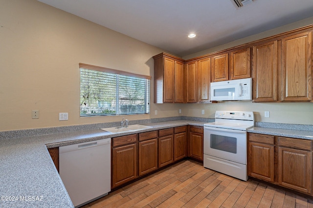 kitchen featuring light hardwood / wood-style floors, sink, and white appliances