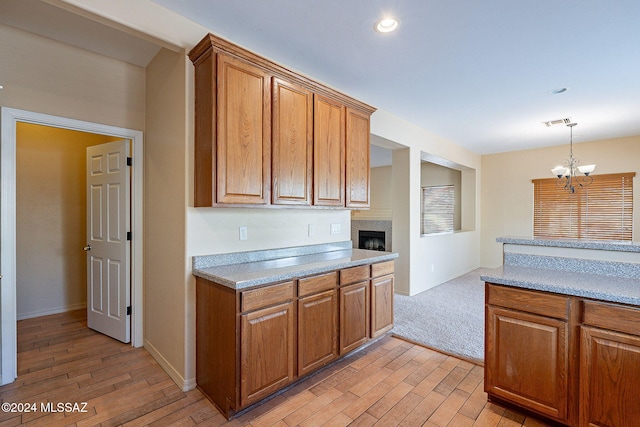 kitchen featuring a chandelier, light wood-type flooring, and decorative light fixtures