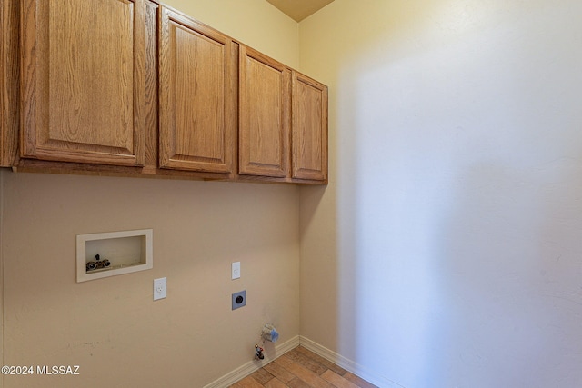 laundry area featuring cabinets, hookup for a gas dryer, washer hookup, and electric dryer hookup