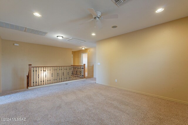 carpeted spare room with ceiling fan