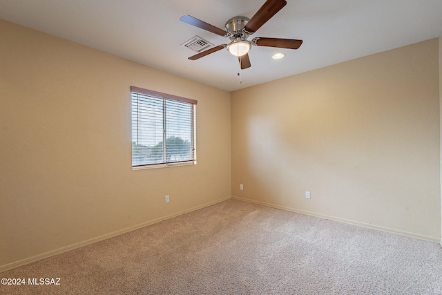 empty room featuring carpet flooring and ceiling fan