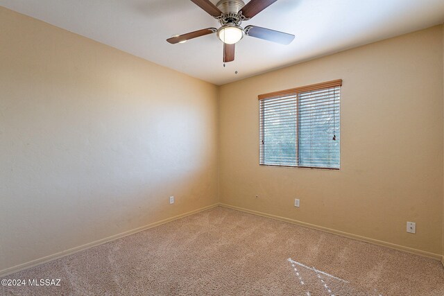 unfurnished room featuring carpet floors and ceiling fan