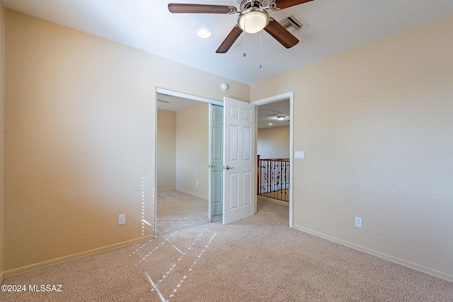 unfurnished bedroom featuring ceiling fan and light colored carpet