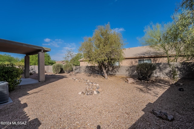 view of yard featuring a patio and central AC unit