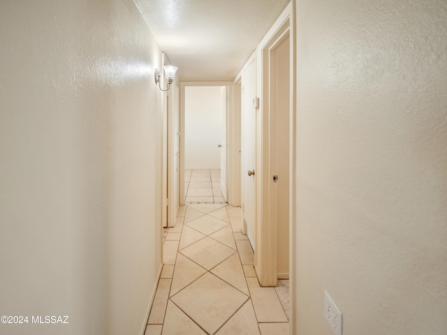 hallway featuring light tile patterned floors