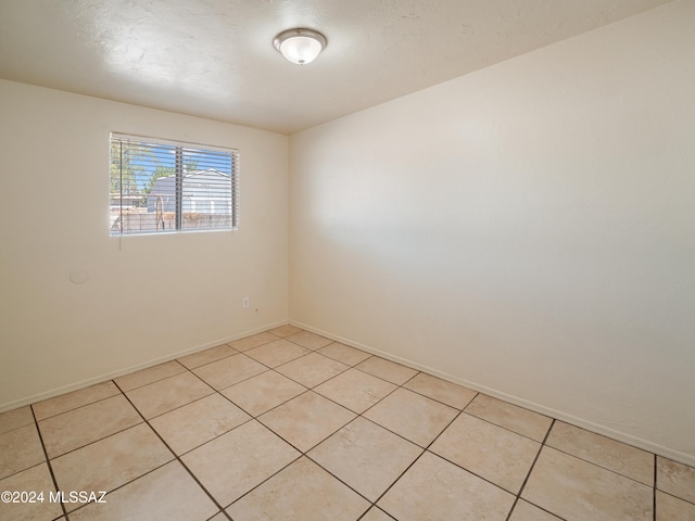 empty room featuring light tile patterned floors