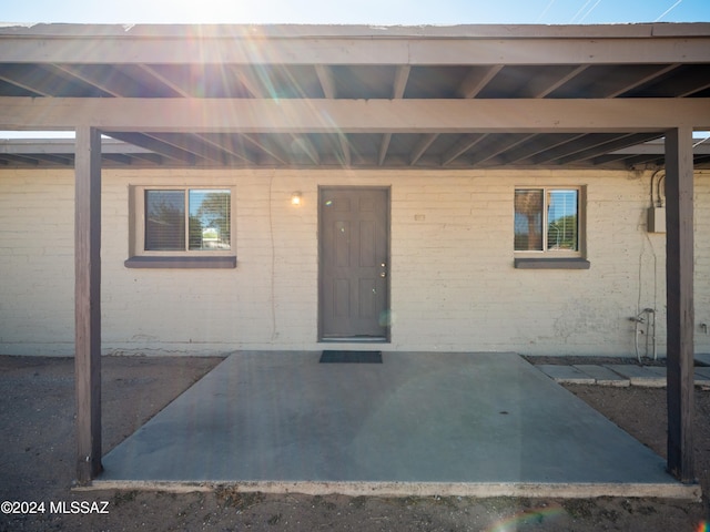 property entrance featuring a patio area