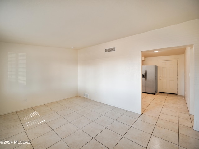 spare room with light tile patterned floors