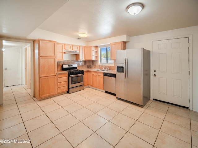 kitchen with light brown cabinetry, appliances with stainless steel finishes, sink, and light tile patterned floors