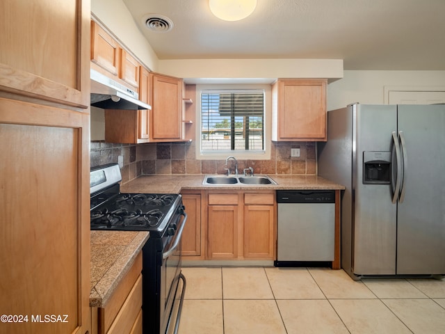 kitchen with light brown cabinets, light tile patterned floors, backsplash, sink, and stainless steel appliances