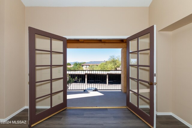 entryway featuring french doors, baseboards, and wood finished floors