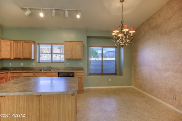 kitchen featuring a chandelier, light brown cabinets, a sink, baseboards, and dishwasher