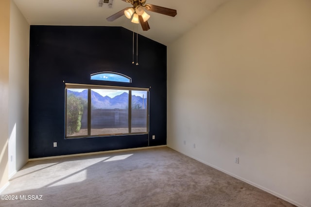 carpeted empty room with ceiling fan, visible vents, high vaulted ceiling, and baseboards