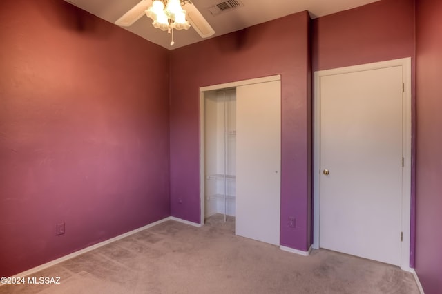 unfurnished bedroom featuring carpet, a closet, visible vents, and ceiling fan