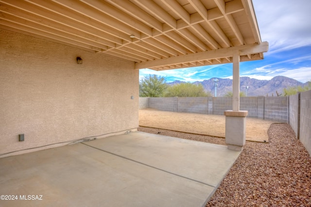 view of patio featuring a fenced backyard and a mountain view