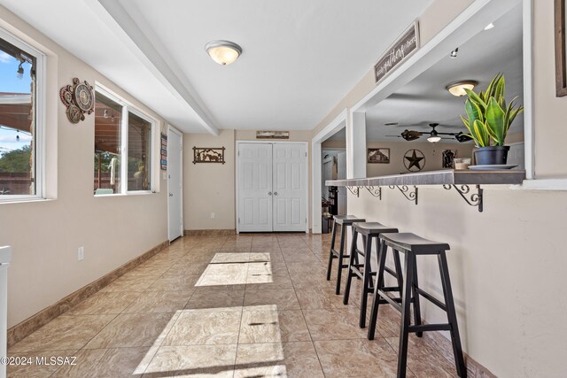 interior space with ceiling fan