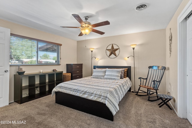 bedroom featuring a closet, light carpet, and ceiling fan