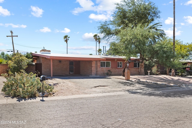 view of front of property featuring a carport