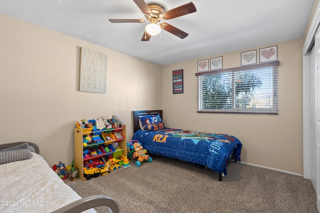 carpeted bedroom with a closet and ceiling fan