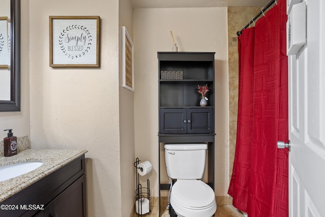 bathroom featuring toilet, curtained shower, and vanity