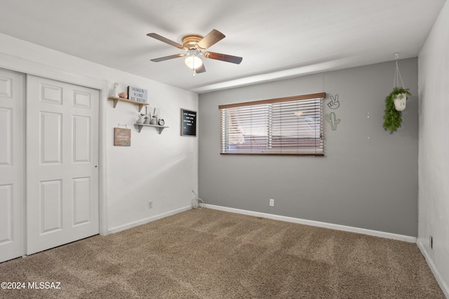 spare room featuring carpet and ceiling fan