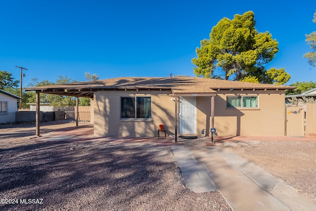 back of property with a carport