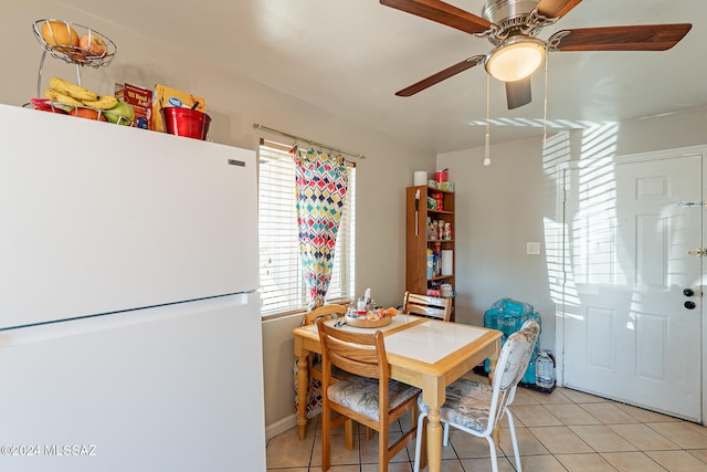 dining space with ceiling fan and light tile patterned floors