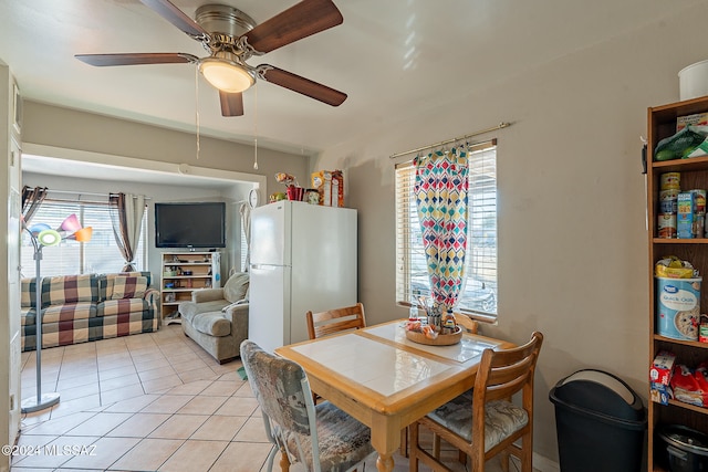 tiled dining room featuring ceiling fan