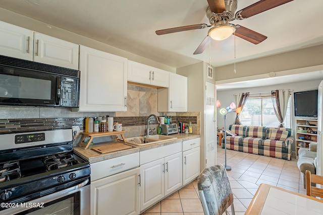 kitchen featuring white cabinetry, stainless steel range with gas cooktop, sink, and tasteful backsplash