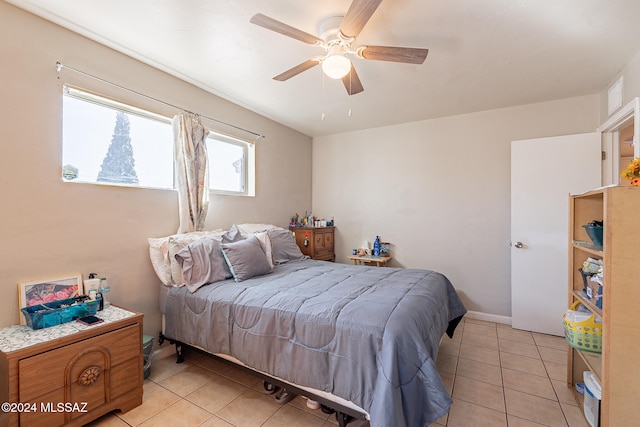 bedroom with light tile patterned floors and ceiling fan