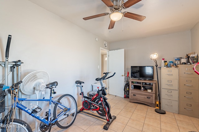 workout room with ceiling fan and light tile patterned floors