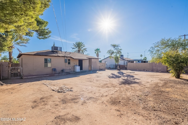 rear view of property featuring a patio and central AC