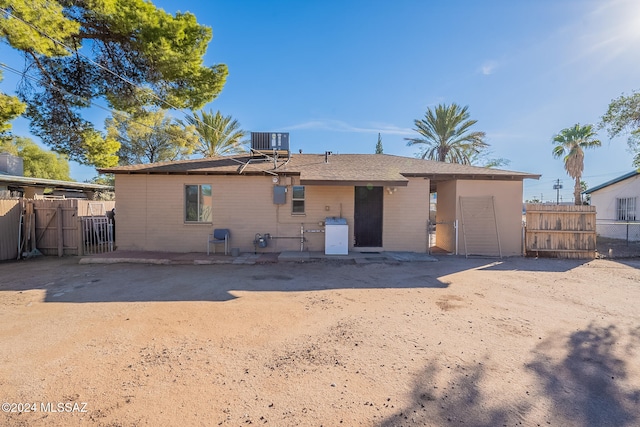 rear view of property featuring central AC and a patio area