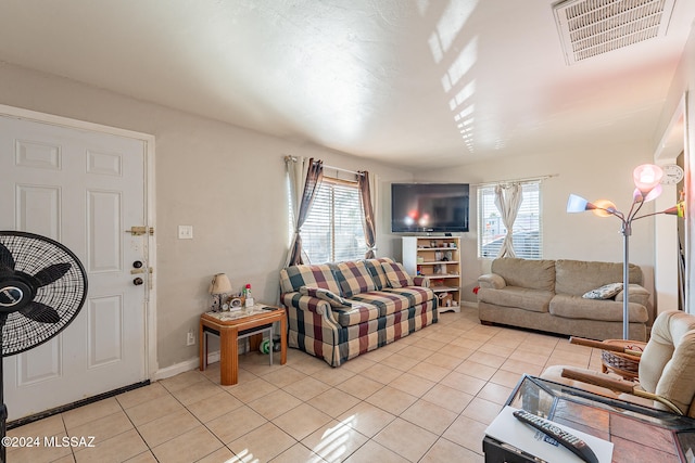 living room with light tile patterned floors and a wealth of natural light