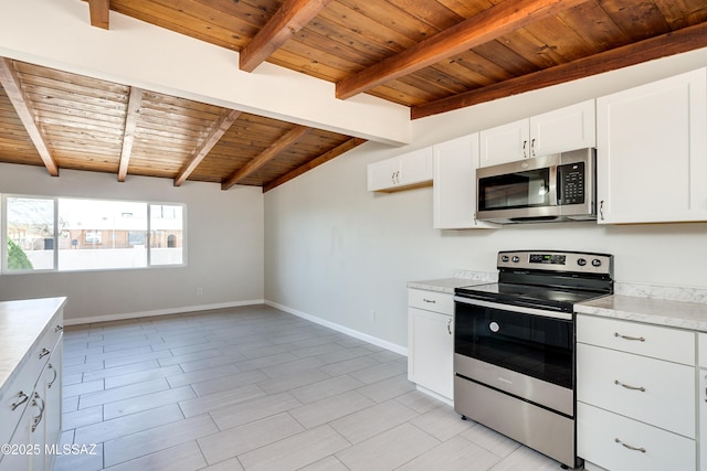 kitchen featuring wood ceiling, appliances with stainless steel finishes, baseboards, white cabinets, and lofted ceiling with beams