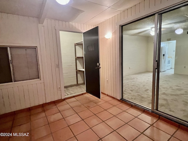 tiled empty room with wood walls