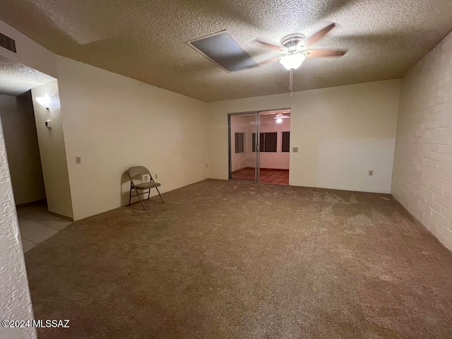 unfurnished room with a textured ceiling, light colored carpet, and ceiling fan