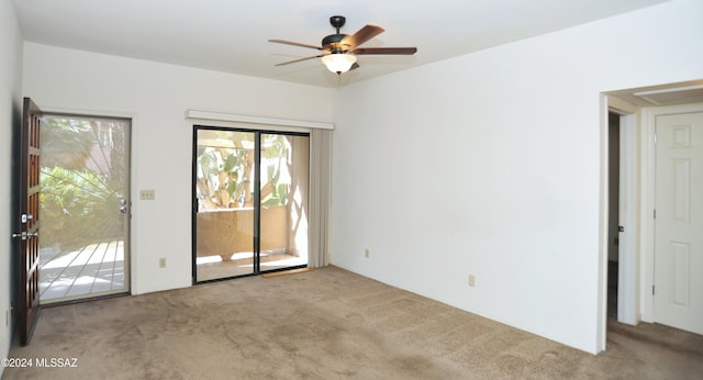 carpeted empty room featuring ceiling fan