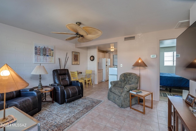 living room featuring ceiling fan and light tile patterned floors