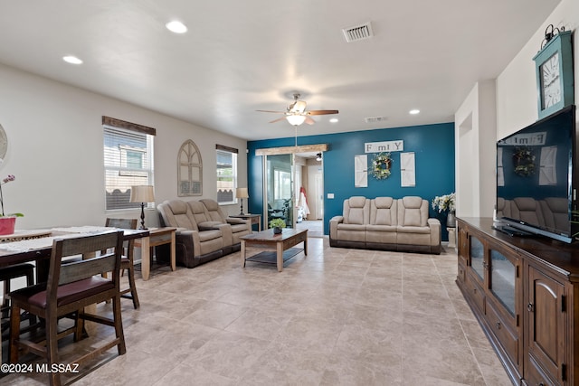 tiled living room with ceiling fan