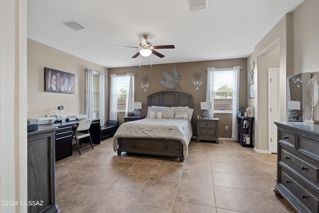 bedroom featuring light tile patterned flooring, multiple windows, and ceiling fan