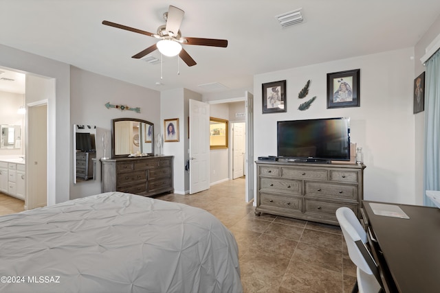 tiled bedroom featuring ensuite bath and ceiling fan