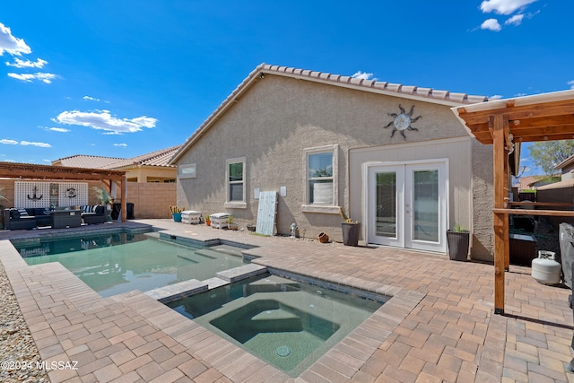 view of pool with outdoor lounge area, an in ground hot tub, french doors, and a patio