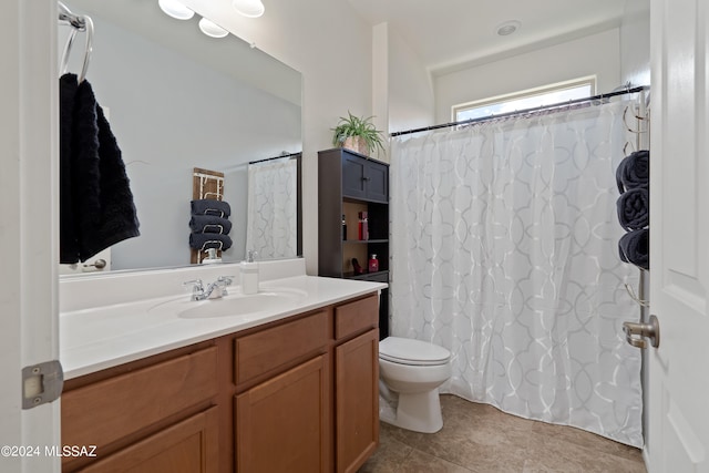 bathroom with tile patterned floors, vanity, and toilet