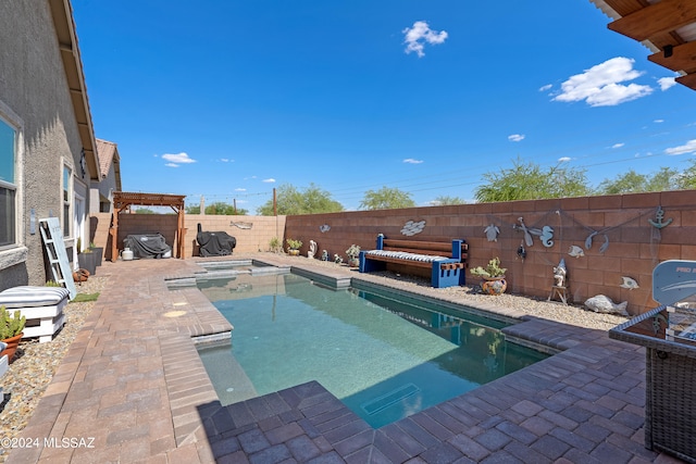 view of pool with a patio area and an in ground hot tub