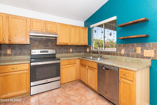 kitchen featuring stainless steel appliances, lofted ceiling, sink, and decorative backsplash