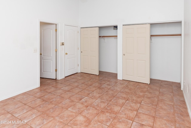 unfurnished bedroom featuring multiple closets