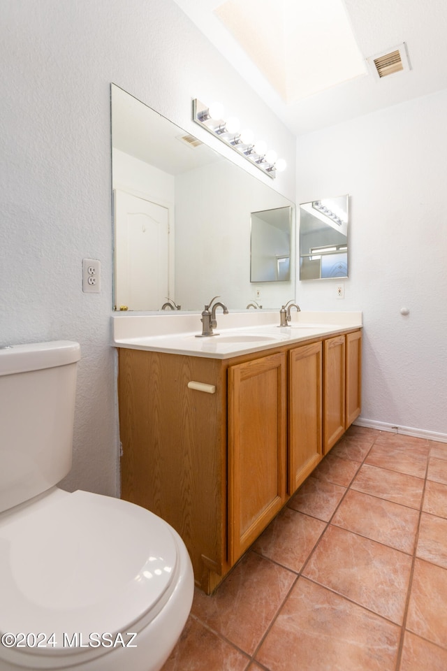 bathroom with vanity, toilet, and tile patterned flooring