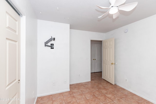 spare room with light tile patterned floors and ceiling fan