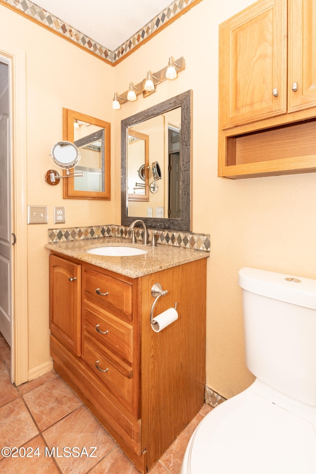 bathroom with vanity, toilet, and tile patterned flooring